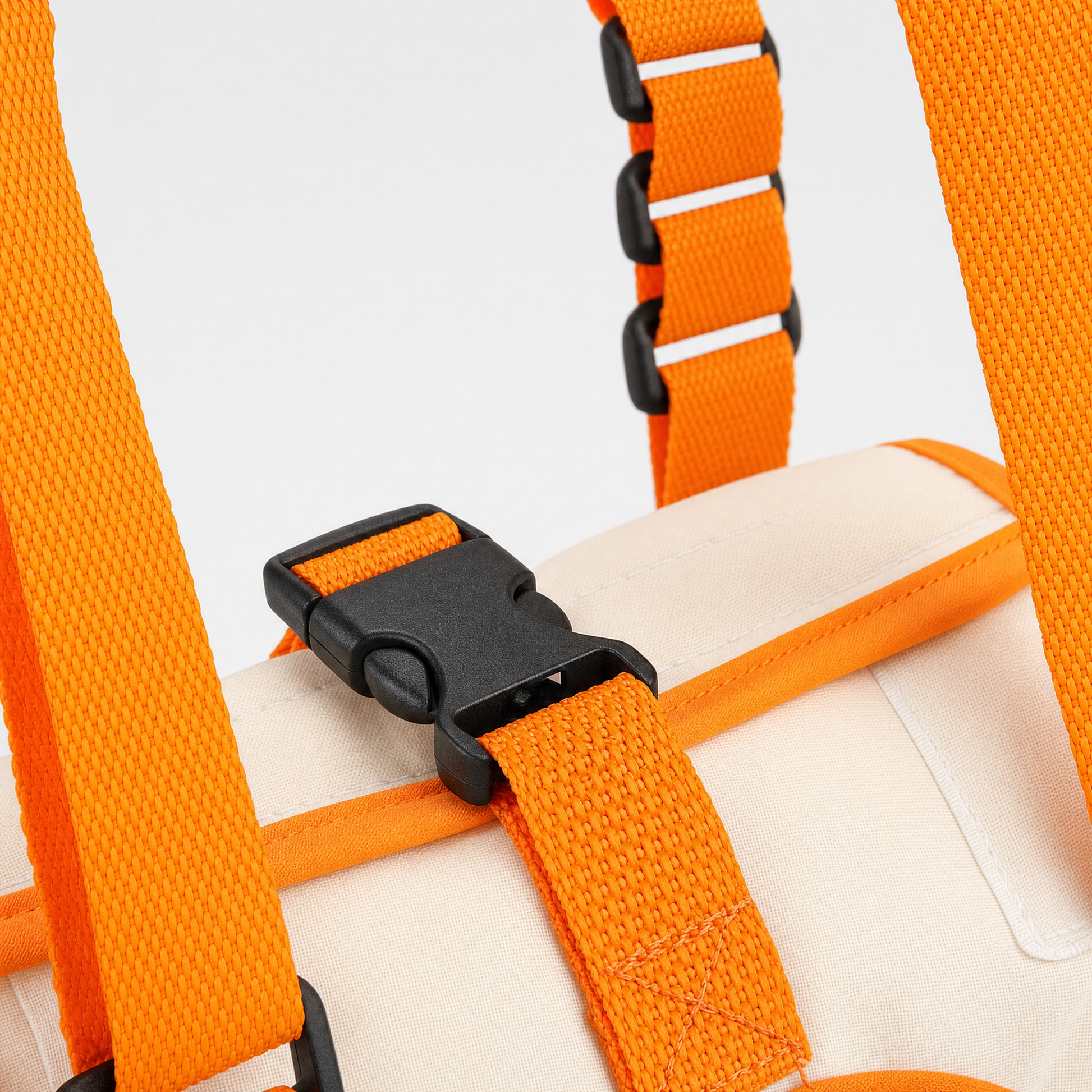 Close-up of orange straps with a black buckle on a white background